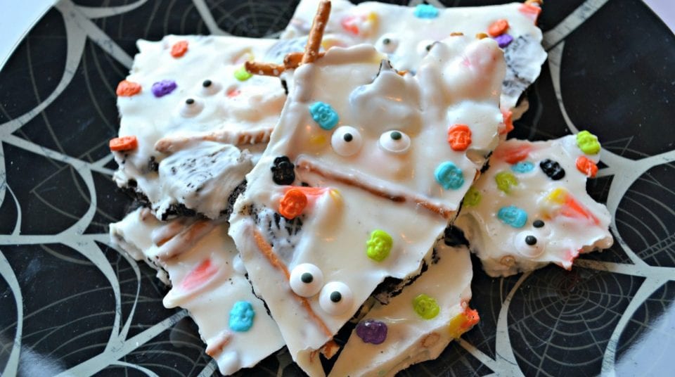 Halloween bark with candy eyes and colorful candies on a spiderweb plate.
